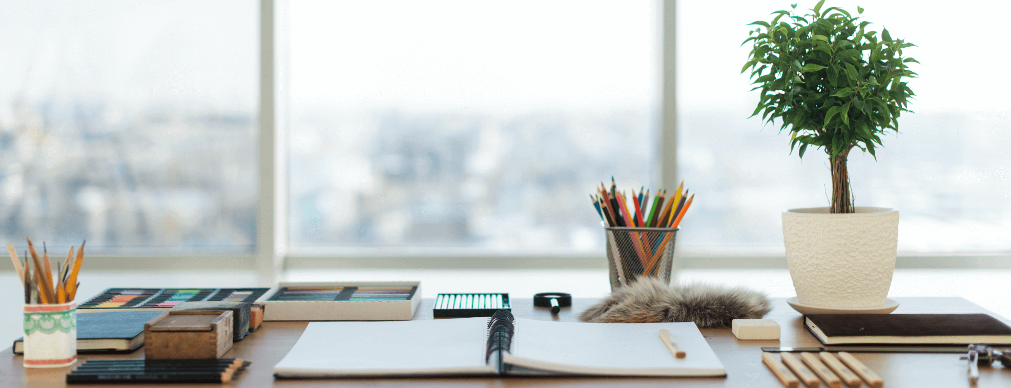 Organized table with a notebook looking at the city